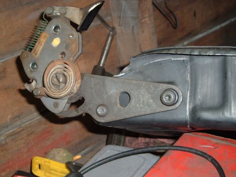 1990 Ford Ranger - A close-up view of a mechanical assembly, likely a brake or clutch mechanism, featuring springs, levers, and a coiled spring. The part is m…