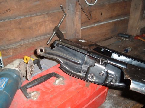 1990 Ford Ranger - A close-up view shows a metal part, possibly from a vehicle frame, resting on a red toolbox. Various tools, including an angle grinder and…
