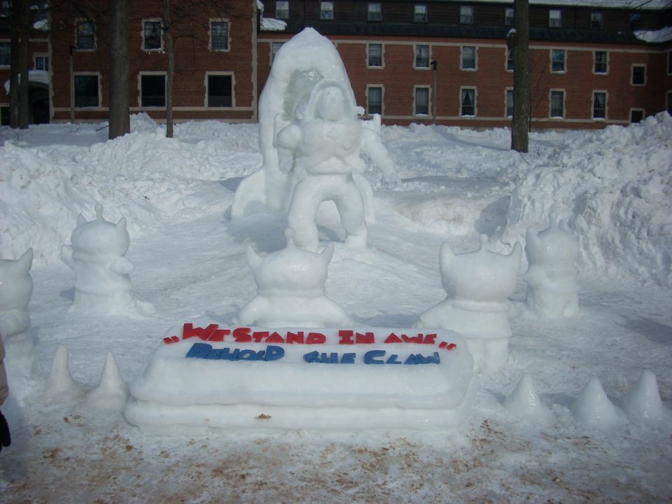 Snow sculpture of Buzz Lightyear and aliens with a sign