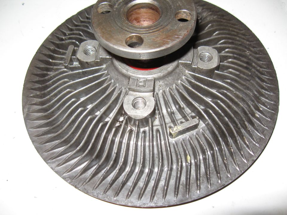 Metal fan clutch assembly with ribbed base and flanged hub.