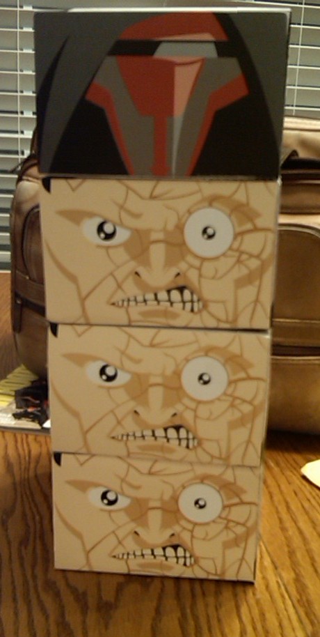 1991 Ford Bronco - Three boxes with cracked face graphics are stacked, topped by a box with a helmet design.