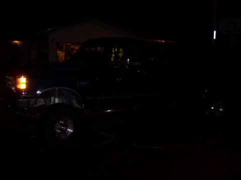 1991 Ford Bronco - A 1991 Ford Bronco is parked outside a garage at night.