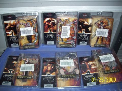 1991 Ford Bronco - Several packaged action figures from Clive Barker's Tortured Souls series are displayed on a blue surface.