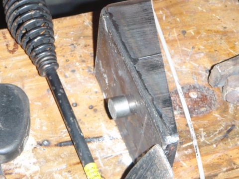 1996 Ford Bronco - A close-up shot of a metal object with a coiled handle, possibly a tool, resting on a wooden surface. The object appears to be part of a la…