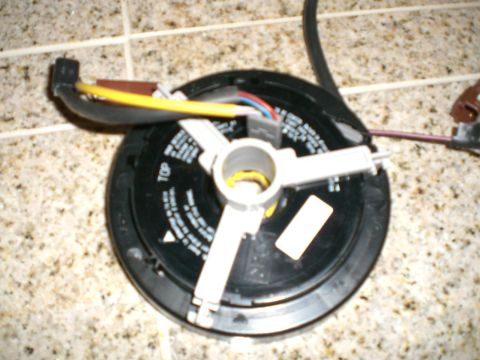 2000 Mercury Grand Marquis - This is a close-up of a vehicle's clock spring assembly, a component often found in the steering column.