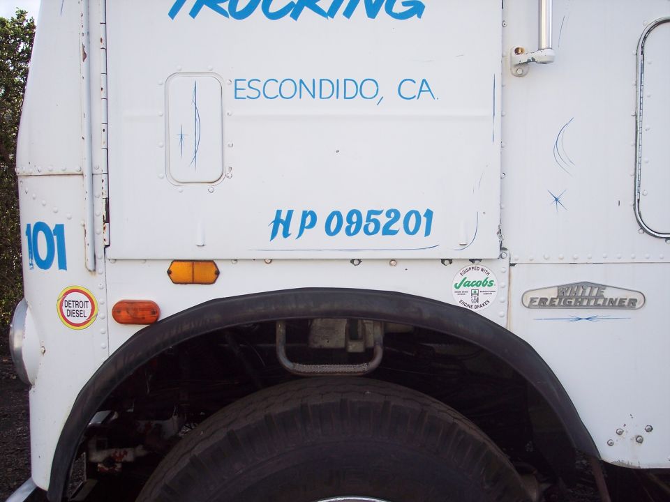 White Freightliner truck side with 'ESCONDIDO, CA.' and 'HP 095201' text
