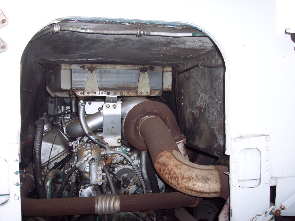engine compartment of a large truck, showing the turbocharger and exhaust piping