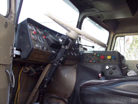 1981 Kenworth W900A - The interior of a truck cab shows the dashboard with multiple gauges and a large steering wheel.