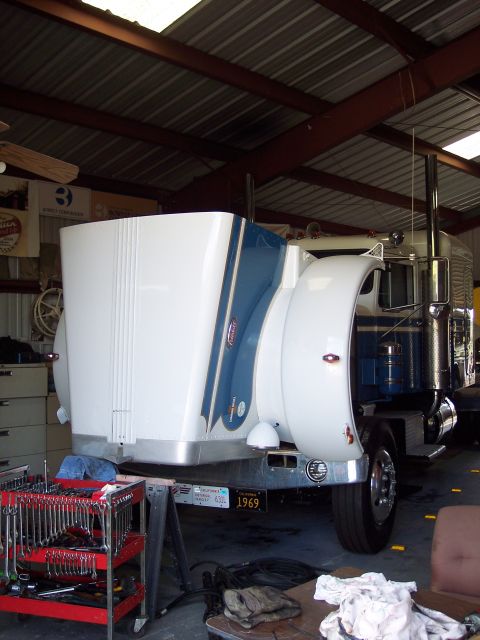 1981 Kenworth W900A - A Peterbilt truck is shown in a garage with a 1969 license plate visible.