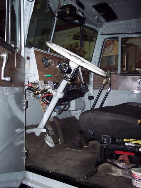 1981 Kenworth W900A - The driver's side of a truck's cab shows the steering wheel, pedals, and part of the seat.