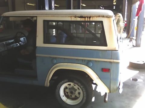 1996 Ford Bronco - A two-door SUV, possibly a Ford Bronco, is shown from the side with its driver's door ajar.