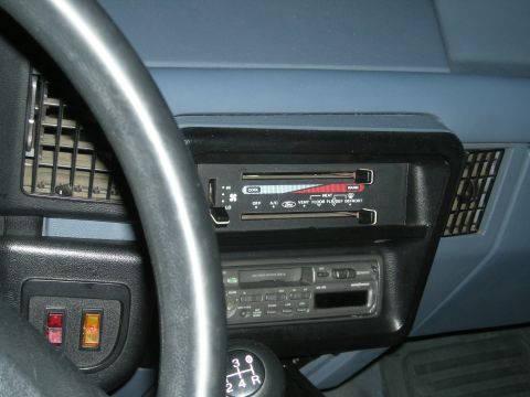 1991 Ford Bronco - Close-up of a vehicle's interior dashboard, showing the climate control panel and radio.