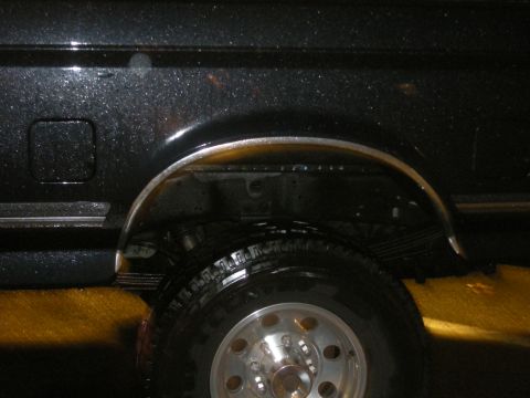 1991 Ford Bronco - Close-up of the rear wheel well on a 1991 Ford Bronco, showing the tire and suspension components.