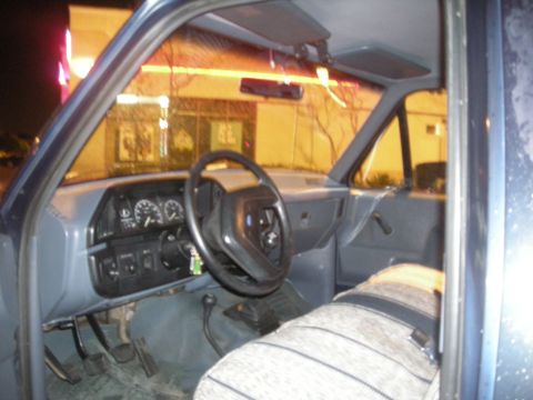 1991 Ford Bronco - Interior view of a truck's dashboard and driver's seat, showing the steering wheel and gauges.