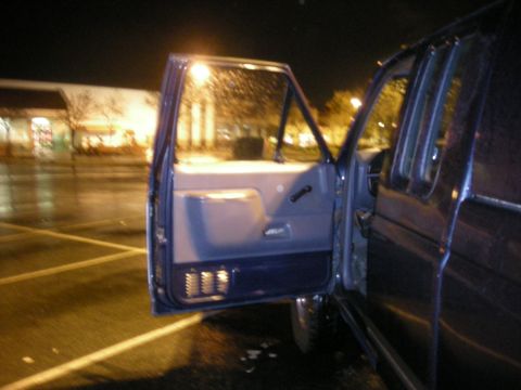1991 Ford Bronco - The interior door panel of a 1991 Ford Bronco is visible with the door open at night.