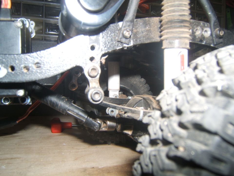 Close-up of RC crawler suspension and drivetrain components