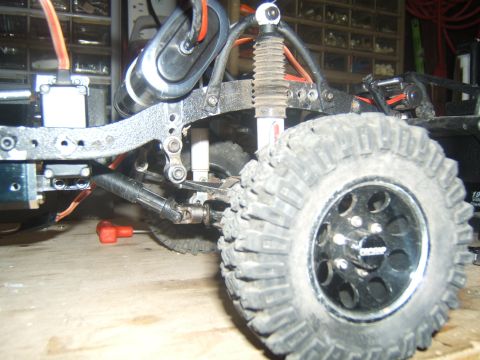 1988 Ford Bronco - Close-up view of an RC crawler's suspension system and large off-road tire.
