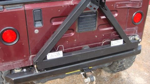 1995 Ford Bronco - This Jeep Wrangler features a rear-mounted spare tire carrier and an aftermarket bumper, with visible aftermarket lights.