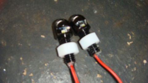 1995 Ford Bronco - Close-up of two LED lights with red wiring, likely for automotive use.