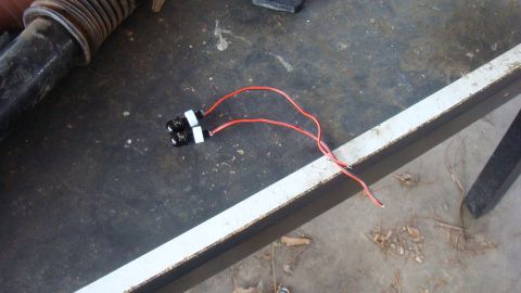 1995 Ford Bronco - Close-up of two LED tail lights with exposed wiring, resting on a surface.