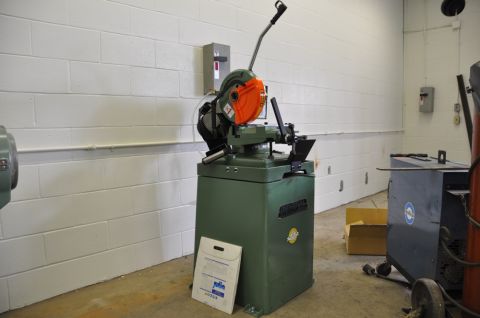 1996 Ford Bronco - A metal cutting saw is shown in a workshop setting with a document on the floor.