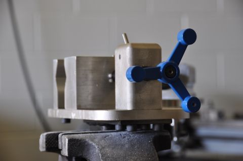 1996 Ford Bronco - Close-up of a metal vise with a blue handle, likely a tool for metalworking.