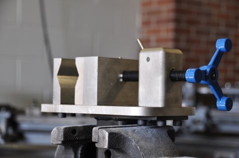 1996 Ford Bronco - A metal vise with a blue handle is secured to a larger vise, ready for use.