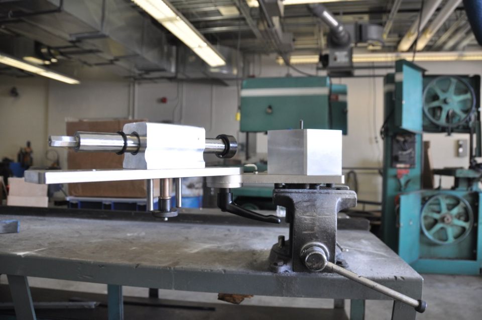 Machinery and a vise on a workbench in a workshop