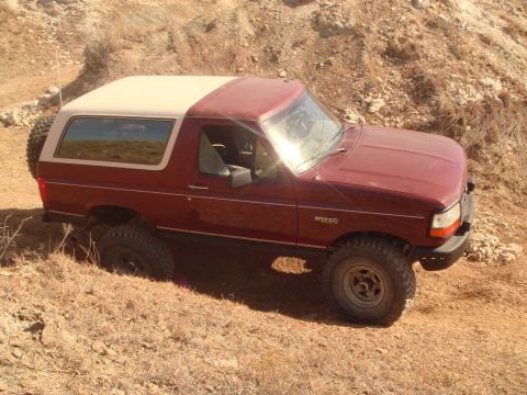 1992 Ford Bronco - This 1992 Ford Bronco is shown off-roading on a dry, dusty terrain.