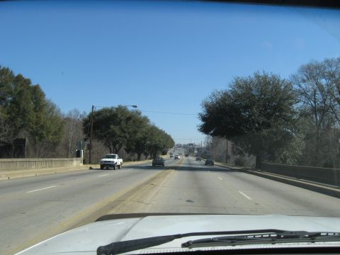 1988 Ford C-350 (Centurion Conversions) - View from inside a vehicle driving down a highway on a clear day.