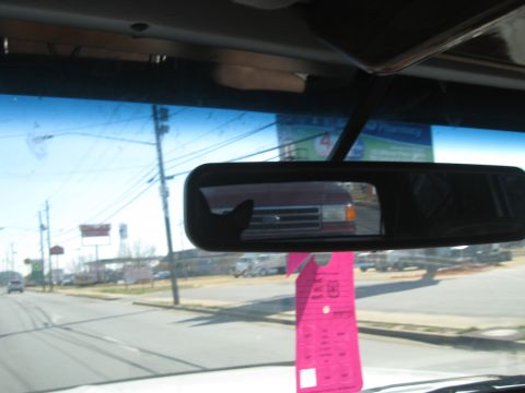 1988 Ford C-350 (Centurion Conversions) - Reflection of a red van in the rearview mirror, likely from the 1980s.