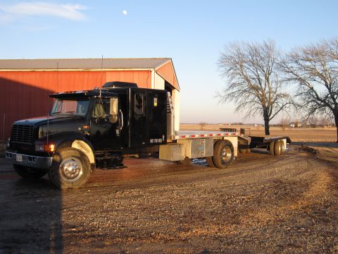 1992 Ford Bronco - Photograph of a flatbed truck and trailer outdoors, not a technical document.