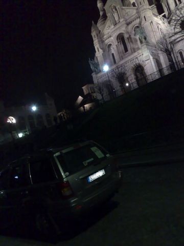 1991 Ford LTD Crown Victoria - Nighttime photograph of an SUV before the Sacre-Coeur basilica, not a technical document.