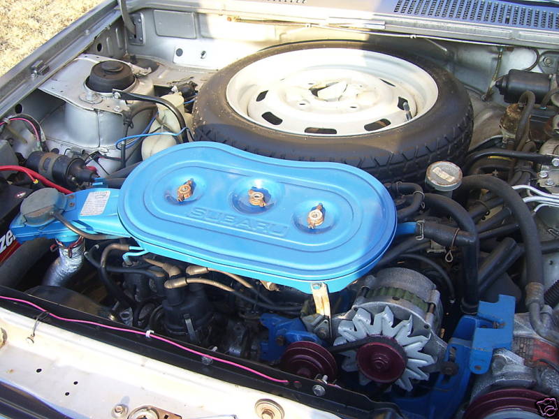 Subaru Brat engine bay with blue air cleaner and spare tire