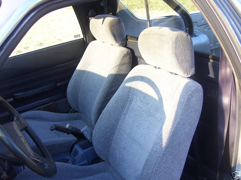 Interior of a Subaru Brat showing front seats, steering wheel, and center console.