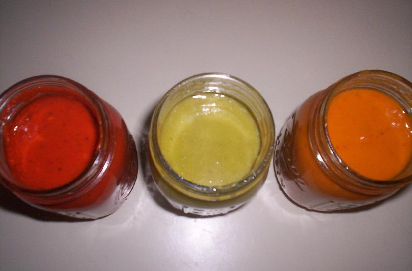 Three jars of sauce: red, green, and orange.