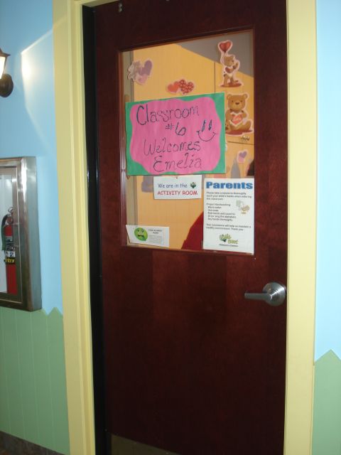 2000 Ford Crown Victoria - A classroom door with a sign welcoming Emelia and a notice for parents about handwashing.