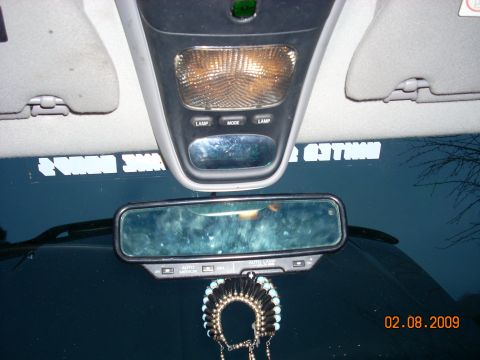 2004 Ford Ranger - Interior view of a vehicle looking up at the overhead console and rearview mirror. White text is visible on the windshield.