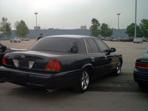 2000 Ford Crown Victoria - Rear view of a black 2000 Ford Crown Victoria in a parking lot.