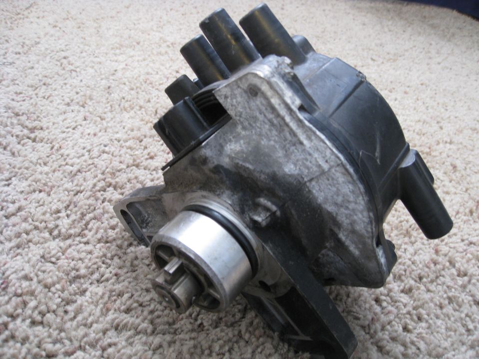 Vehicle distributor cap and rotor assembly on carpet