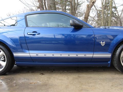 1992 Ford Bronco - Photograph of a blue Mustang side profile, not a technical document.