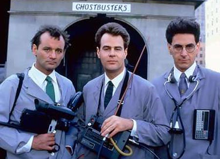 1989 Ford Bronco - Three men in uniform stand in front of a building with "GHOSTBUSTERS" written above an archway. The men are holding equipment that appears…