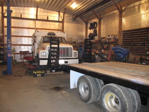1992 Ford Bronco - Photograph of a GMC truck in a shop, not a technical document.