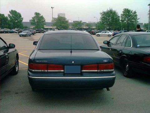 2000 Ford Crown Victoria - Rear view of a 2000 Ford Crown Victoria parked in a lot with other vehicles.