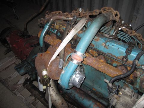 1992 Ford Bronco - Photograph of a rusty diesel engine being lifted by chains, not a technical document.