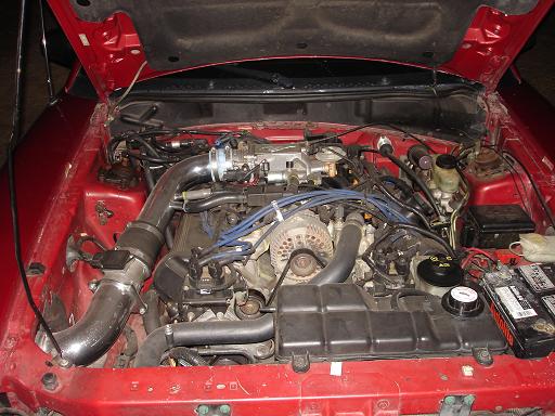 1996 Ford Mustang engine bay with chrome intake and blue spark plug wires