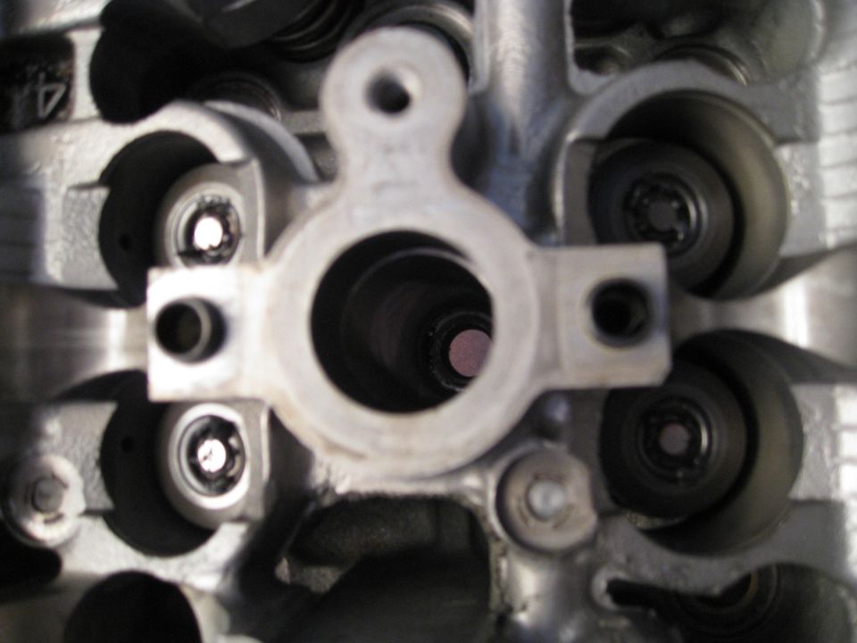 Close-up of internal engine components, cylinder head, valves, springs.