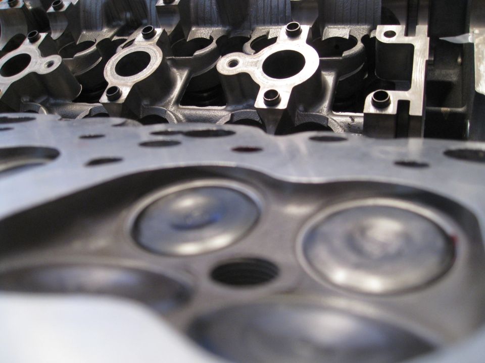 Close-up of engine cylinder head combustion chambers and ports.