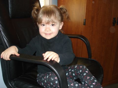 2000 Ford Crown Victoria - A young child sits in a chair, looking towards the camera.