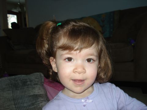 2000 Ford Crown Victoria - A young girl with brown hair and brown eyes smiles at the camera.